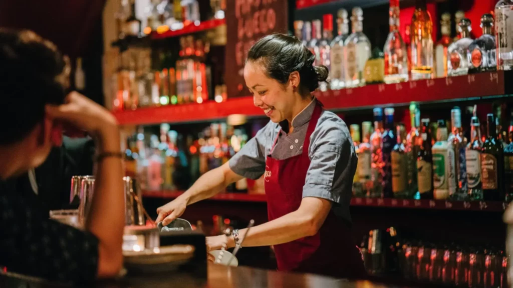 Bar woman serving drinks