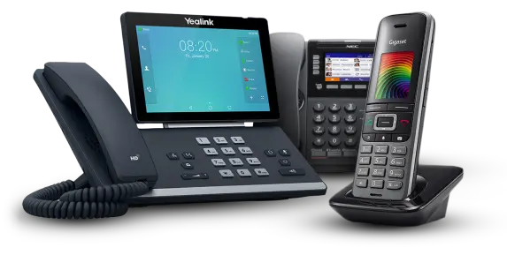 Three business telephones. two of them are desktop phones with digital displays and the third is a cordless phone on it's base station.